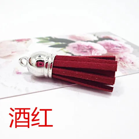 A cluster of deep red velvet tassels with silver metal findings for DIY jewelry and decor.