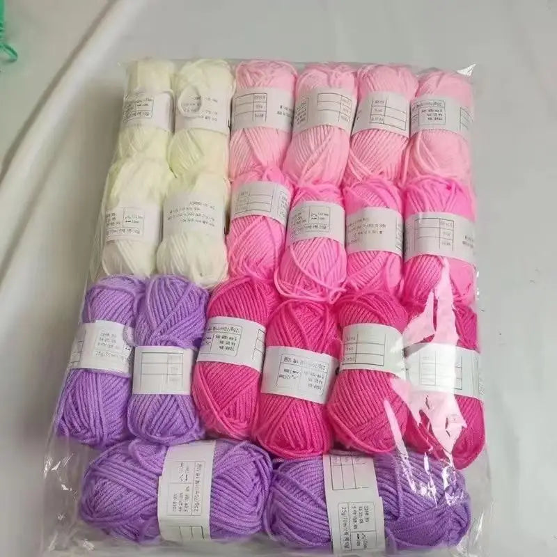 A pack of 20 skeins of milk cotton blend yarn in various shades of pink and purple for knitting and crochet.