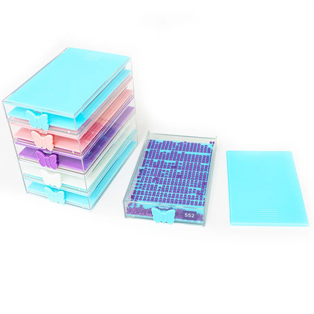 A clear acrylic diamond painting storage tray with a lid, featuring multiple colored plastic storage sheets.