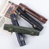 Three brown and green foldable dice rolling trays made of PU leather displayed next to a newspaper.