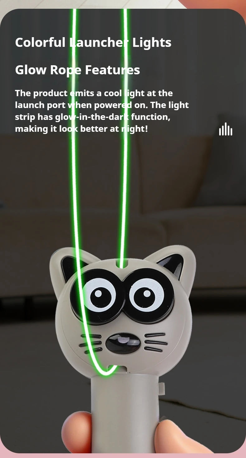 A hand holds a white cat toy with black markings, featuring glowing green rope lights.