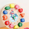 A wooden sorting clock featuring penguin-shaped numbers and shapes for teaching the concept of time to babies.