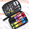 A black travel storage box containing a complete sewing kit with various tools and threads.