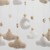 Handmade felt baby mobile featuring a crescent moon and fluffy clouds hanging from strings.