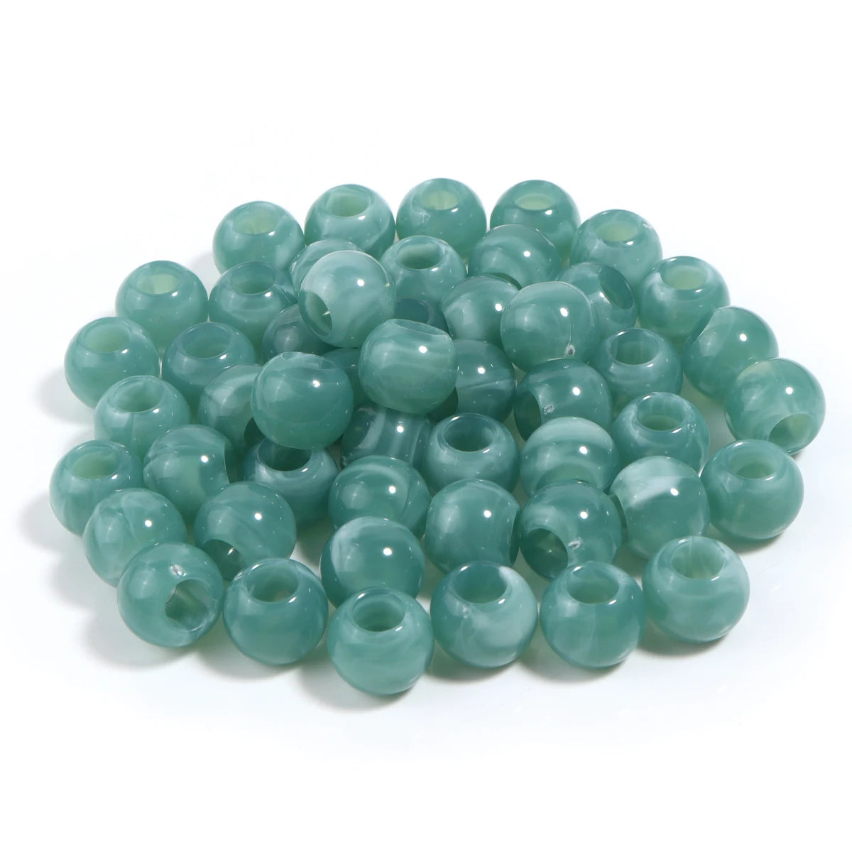 A pile of 50 imitation jade acrylic cloud beads in a light green color for jewelry making.