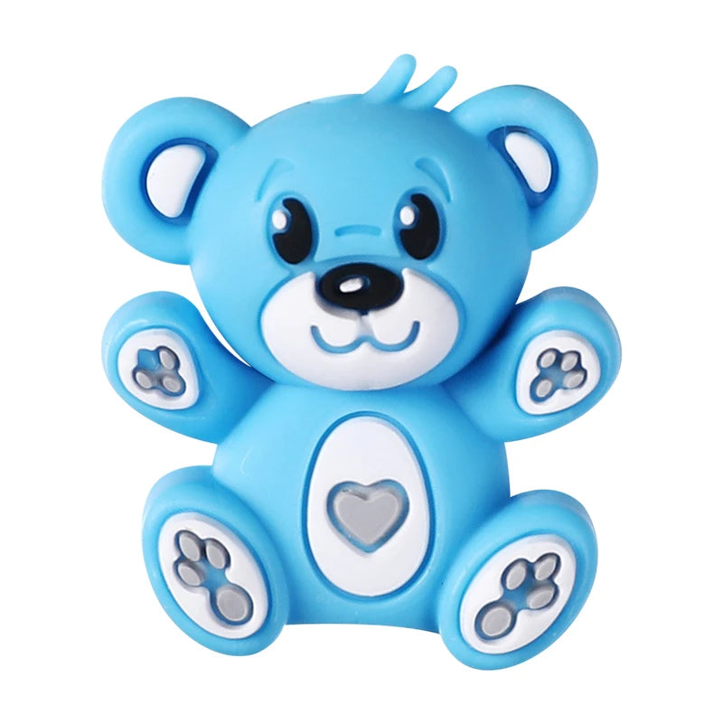 A cute, light blue silicone bear figure with facial beads and decorative elements for DIY jewelry making.