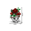 A building blocks set depicting a gothic floral skull with red roses and green leaves.