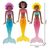 A set of four mermaid dive toys featuring purple, black, and yellow skin tones with iridescent scales.