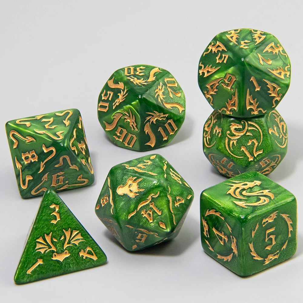A set of marble dragon pattern polyhedral dice in various shapes and sizes, featuring gold markings on a green marbled surfac