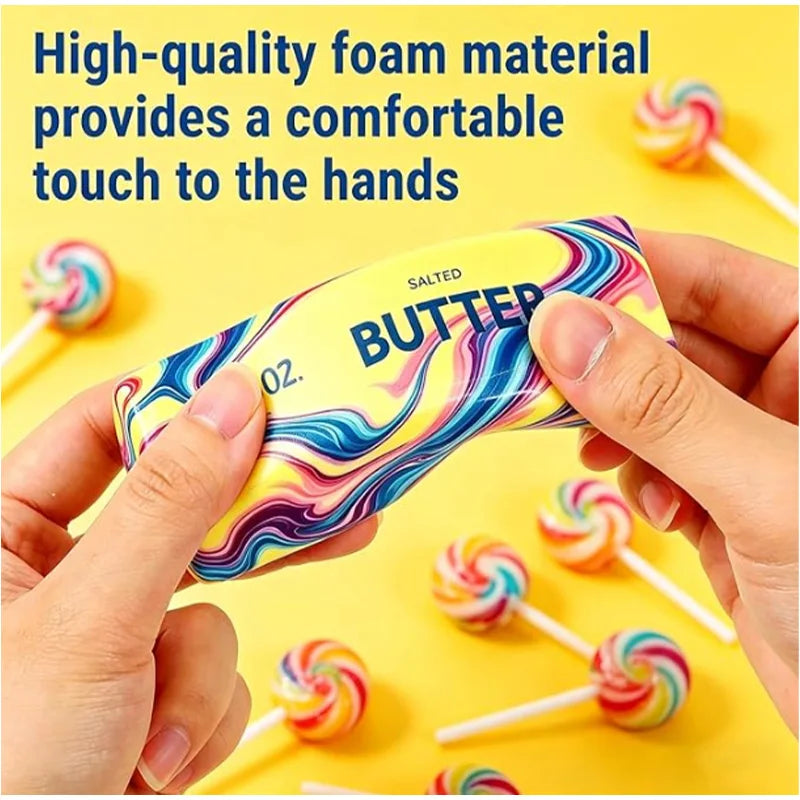 Hands hold a yellow squishy butter toy with colorful swirls, surrounded by other similar toys.