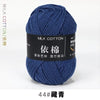 A skein of dark blue milk cotton yarn labeled with the name 依棉 and the number 44# 藏青.