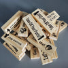 A pile of wooden stacking blocks with various phrases like Take Off Your Shirt and Let's Dance