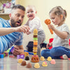 A father and daughter play with a pretend ice cream stacking toy set on a table.