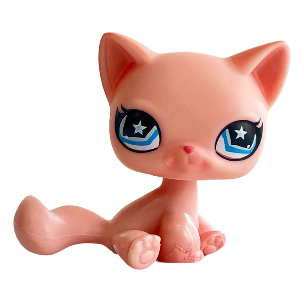 A pink bobble head figurine of a cat with large blue eyes and white markings.