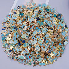 Assorted metal pendants and charms in gold and turquoise colors for jewelry making