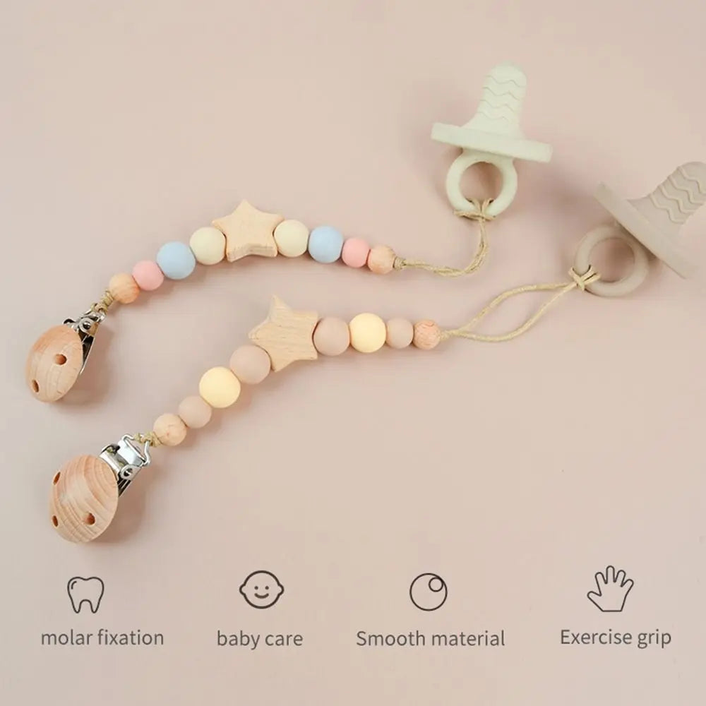 A set of star-shaped wood pacifier clips with silicone beads and silicone rings for baby care and exercise grip.