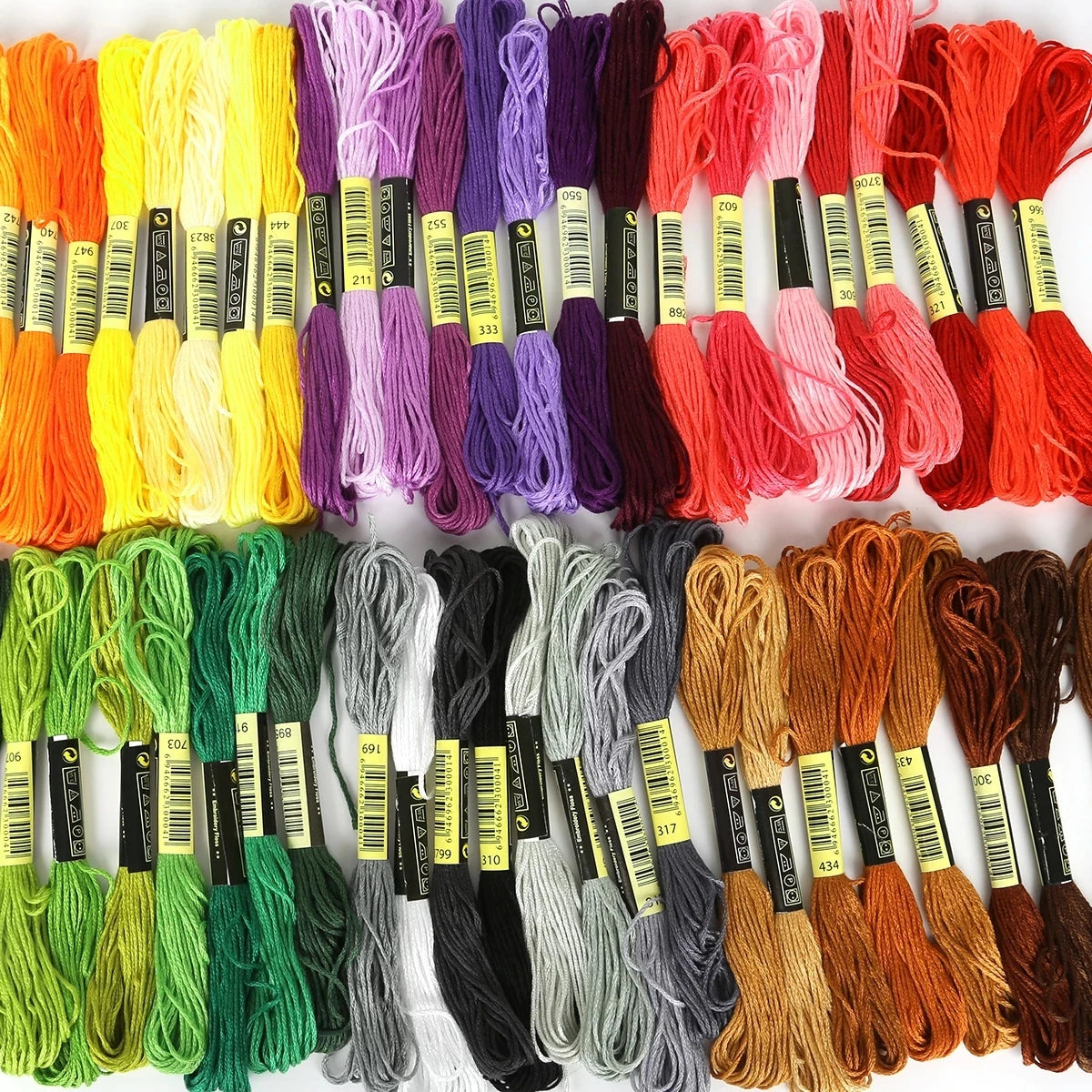 A collection of multicolor embroidery floss skeins in various colors like orange, yellow, purple, and red.