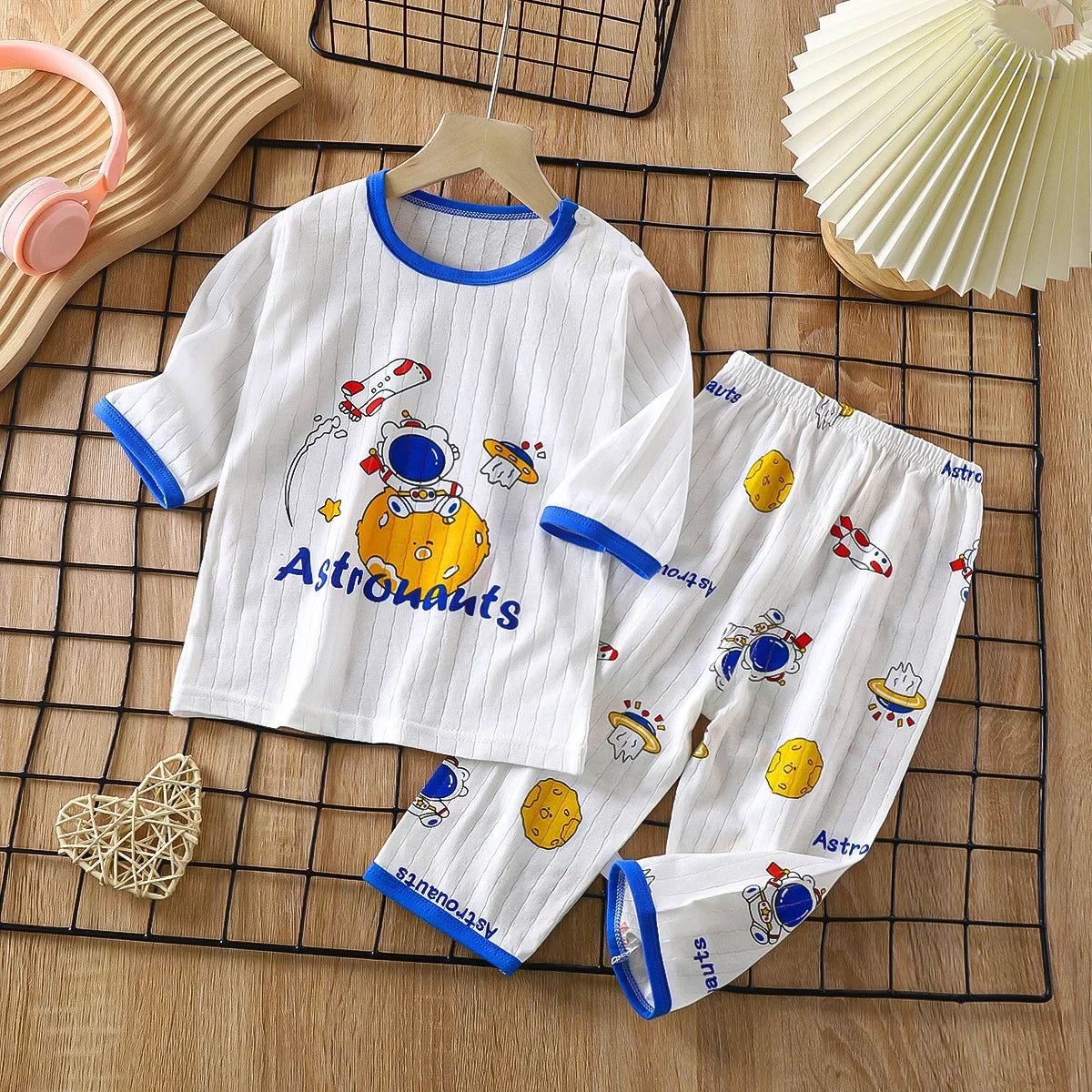 White long sleeve cotton pajama set for children featuring astronaut and space designs