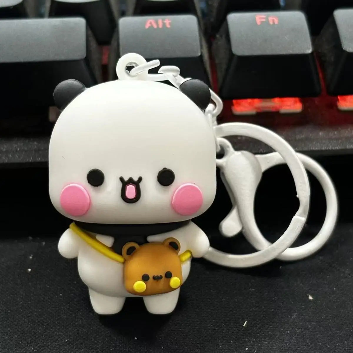 A white cartoon bear and a small brown bear keychain set with a silver ring.