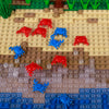 A collection of marine animal building blocks including red and blue sharks, octopuses, and whales on a tan base.