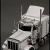 A silver diecast container truck model is shown with a prompt to press the front wheel to activate sound and light functions.