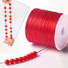 Red elastic beading cord in a spool and as a finished necklace strand