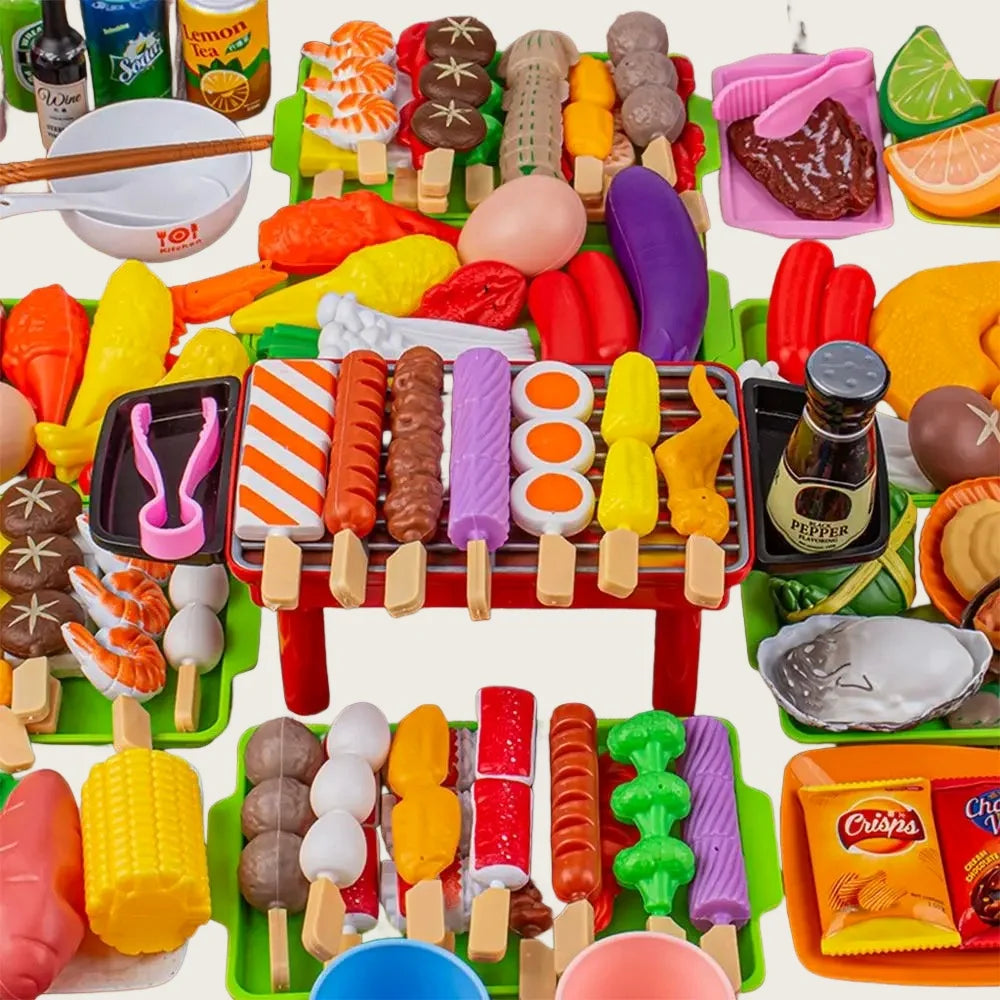A colorful set of toy food items including fruits, vegetables, and meats arranged for pretend play.