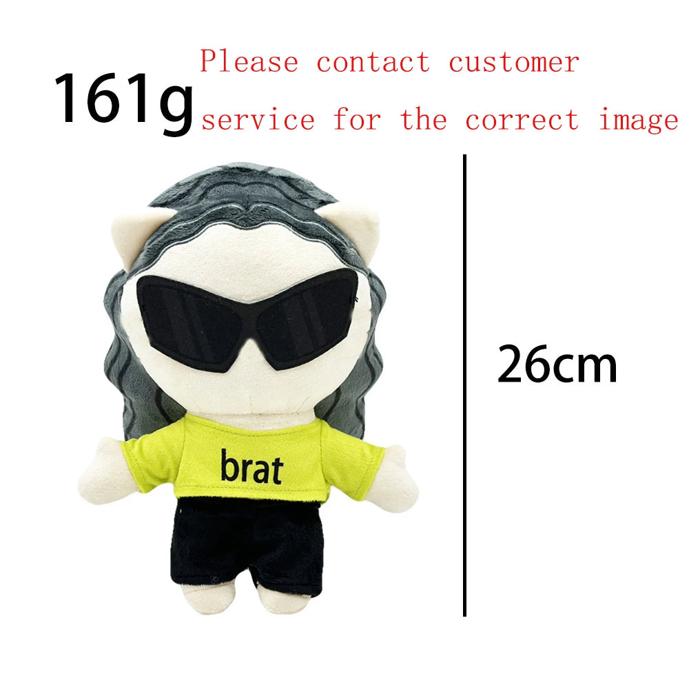 A plush doll resembling a character wearing black sunglasses and a yellow shirt with the word brat on it.