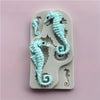 A silicone mold featuring detailed seahorse shapes for resin and clay crafts.