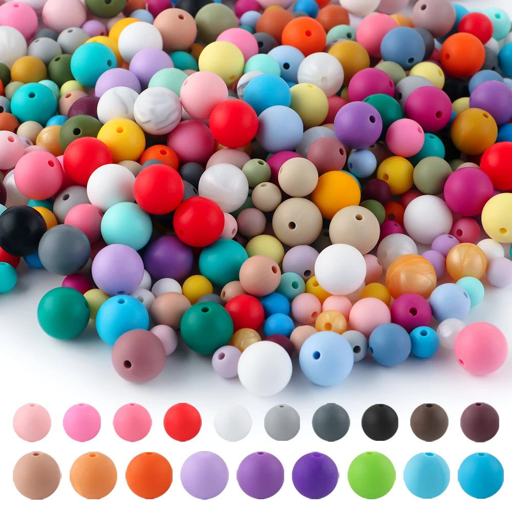 A large pile of colorful soft silicone round beads in various shades including pink, yellow, blue, and green.