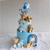 A three-tiered light blue cake decorated with teddy bears and blue balloons for a birthday or baby shower.