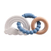 A set of food-grade silicone planet teethers in white, blue, and natural wood tones.