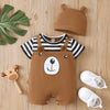 A brown baby bear print short sleeve romper and matching hat are displayed on a wooden surface.