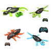 A wall-climbing RC gecko toy with glowing green eyes and orange limbs.