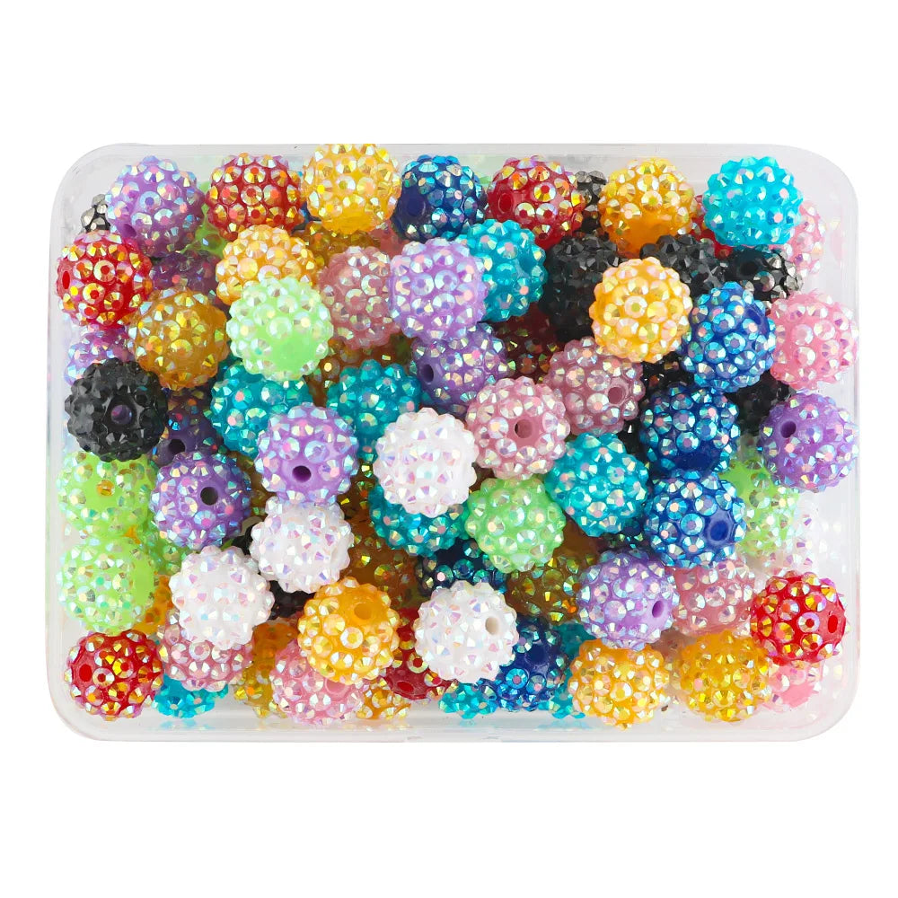 A clear plastic tray filled with colorful rhinestone resin bayberry beads for jewelry making