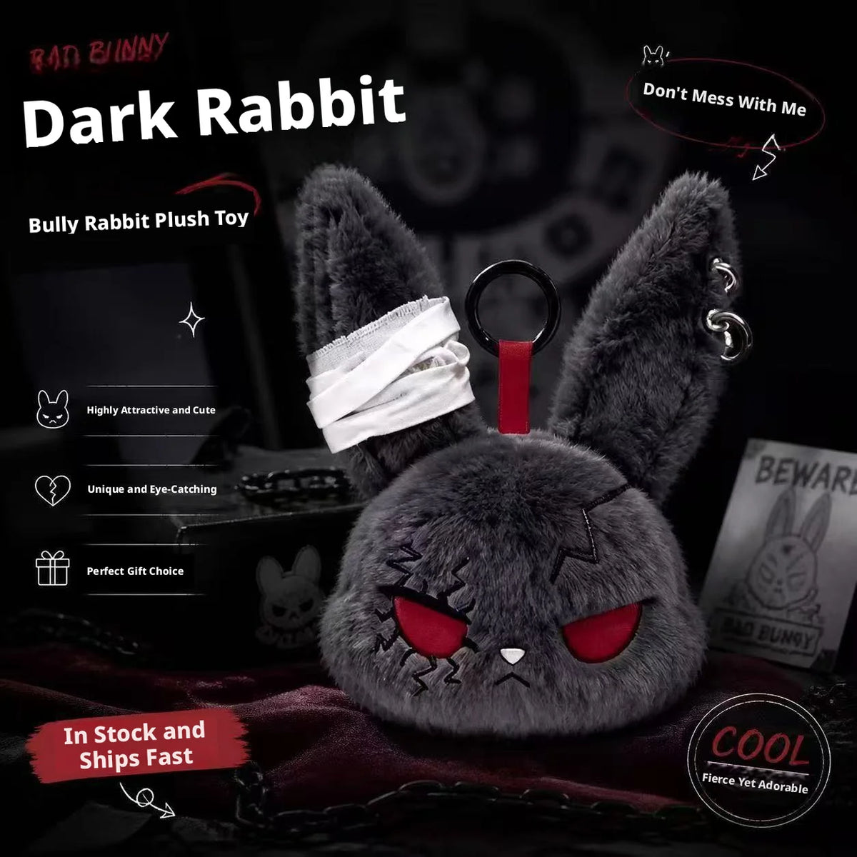 A dark gray rabbit plush toy with red eyes and a white bandage design, shown against a black background.