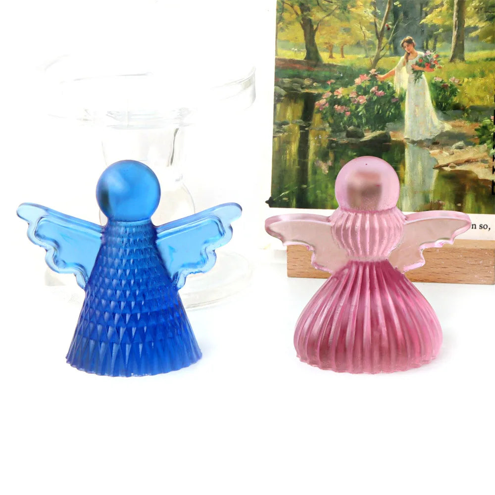 A silicone mold of a cherub angel in blue and pink colors used for making candles or soap.