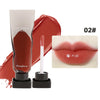 A tube of dark mirror lip glaze in red and a doe-foot applicator are shown next to a swatch of the product on lips.