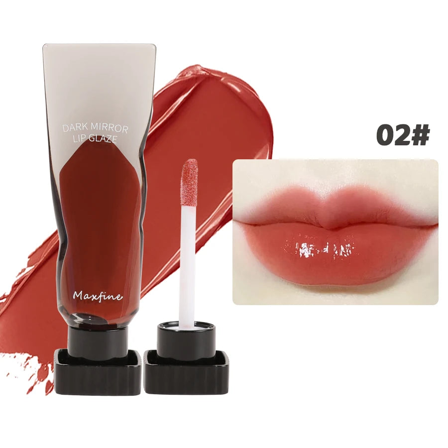 A tube of dark mirror lip glaze in red and a doe-foot applicator are shown next to a swatch of the product on lips.