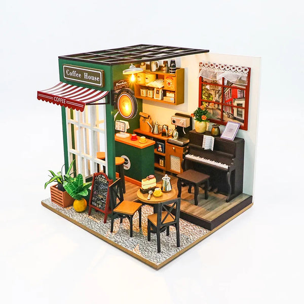 A handmade wooden miniature dollhouse kit depicting a cozy coffee house with shelves, a counter, and a piano.