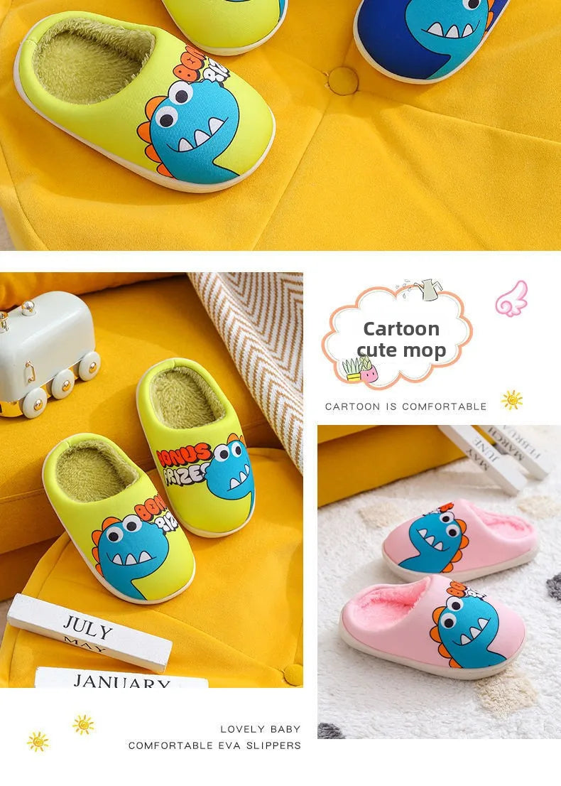 A set of yellow and blue cartoon dinosaur plush slippers for a baby, shown on a yellow fabric background.