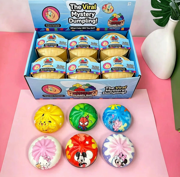 A box of The Viral Mystery Dumpling squishies with various colorful cartoon patterns and a set of individual squishy toys.
