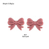 A pair of pink silicone bow tie beads used for jewelry making and craft projects.