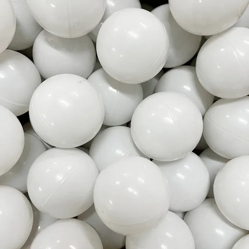 A close-up view of a large quantity of white play balls for ball pits and games.