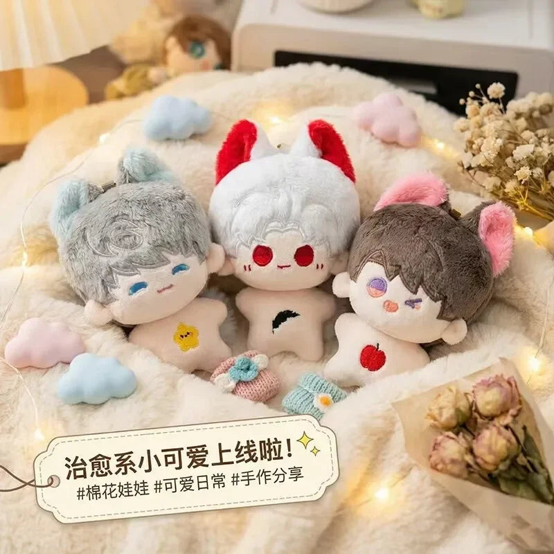 A collection of cute anime plush keychains featuring various characters with pink, red, and gray hair and faces resting on a 