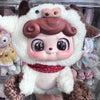 A soft collectible doll plush featuring white fur, brown accents, and large eyes.