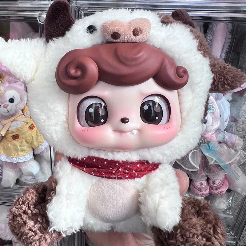A soft collectible doll plush featuring white fur, brown accents, and large eyes.