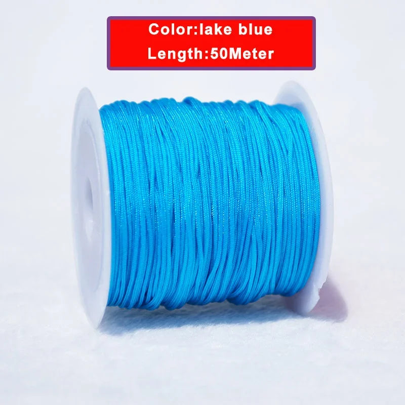 A spool of 50 meter lake blue nylon knotting cord for jewelry making.