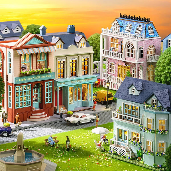 A detailed diorama of a Victorian-style miniature wooden dollhouse kit featuring colorful buildings and landscaping.