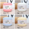 Six rolls of 100% cotton yarn in various colors including pink, white, light blue, and creamy yellow.